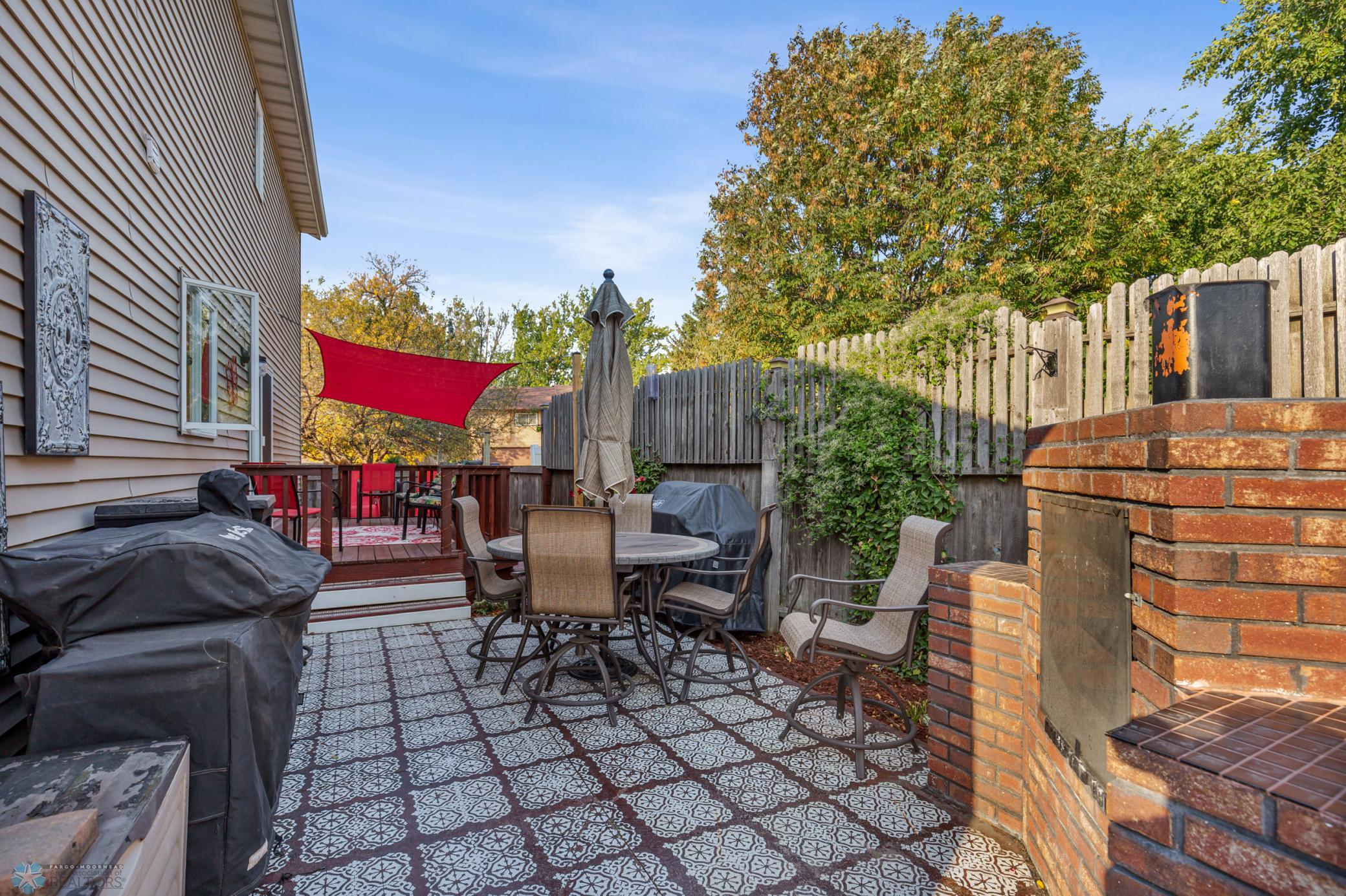 Deck and patio with brick fireplace