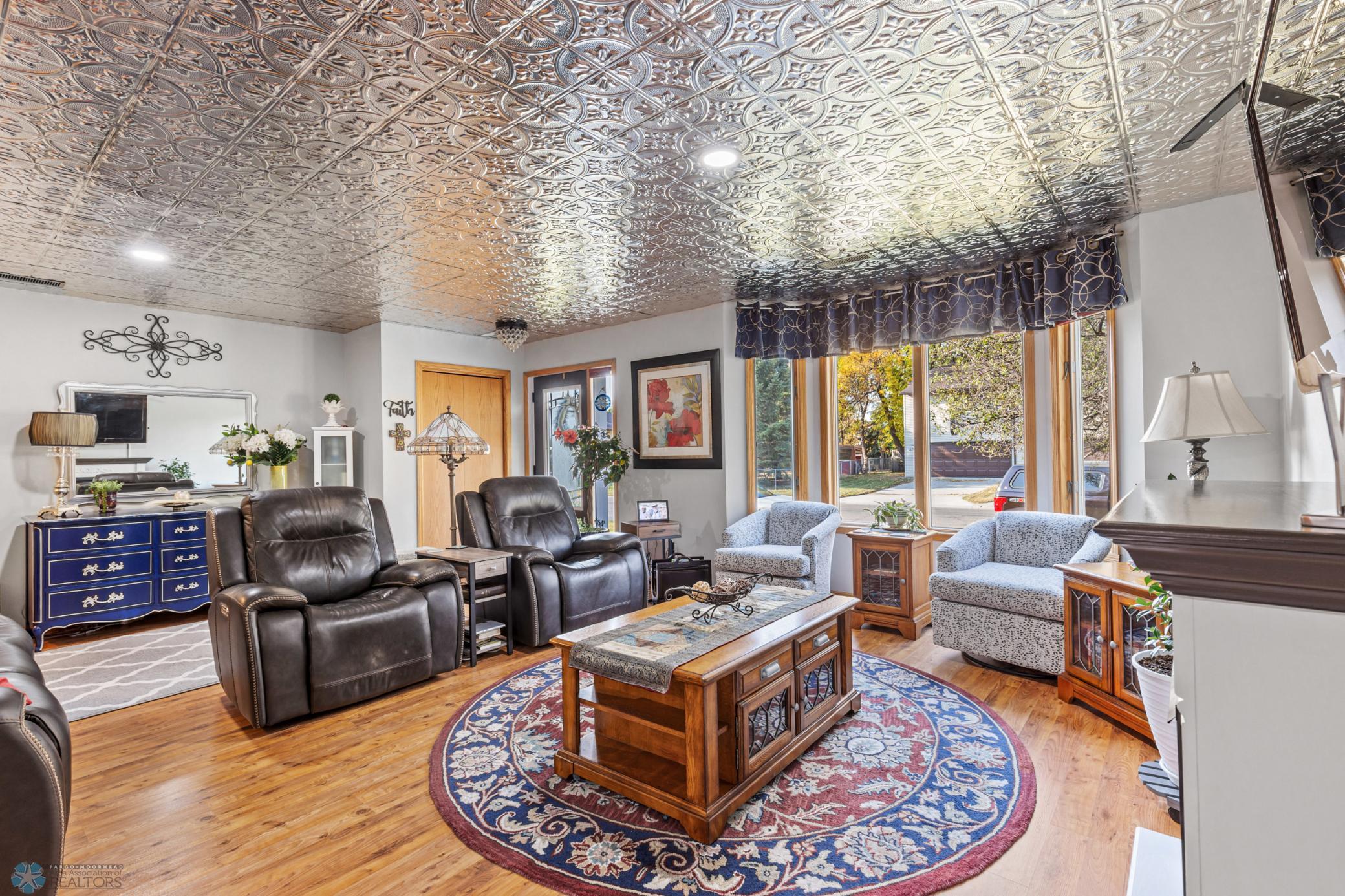 Family room, electric shades on bay wdw