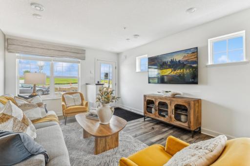 (Photo of a model home, actual homes finishes will vary) The spacious family gathering area seamlessly connects to the kitchen area, perfect for entertaining.