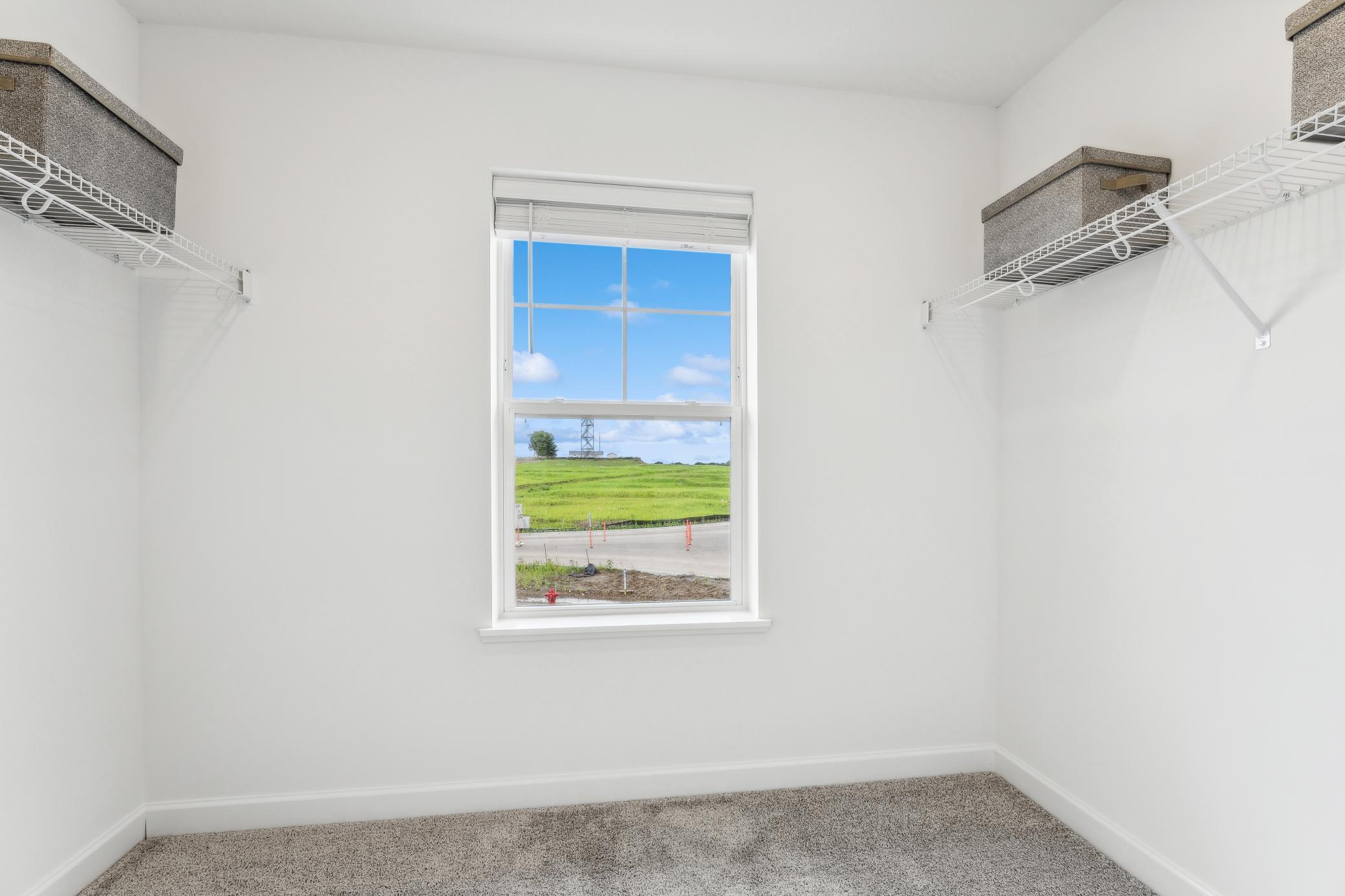 (Photo of a model home, actual homes finishes will vary) Huge Owner's suite closet!