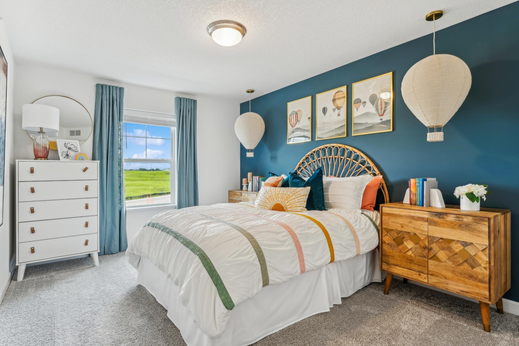 (Photo of a model home, actual homes finishes will vary) One of two generously sized upper level secondary bedrooms with spacious closets.