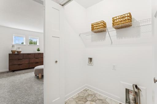 (Photo of a model home, actual homes finishes will vary) Convenient upper-level laundry