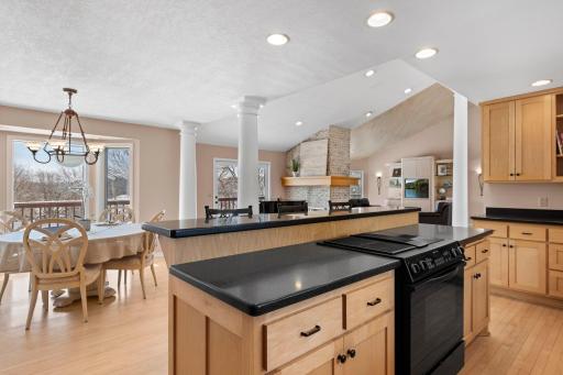 The kitchen is home to generous Corian countertops, custom cabinetry, and a large window framing views of the front yard.