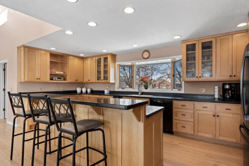 Equipped with a Bosch dishwasher and JennAir electric range, this kitchen offers both function and style.