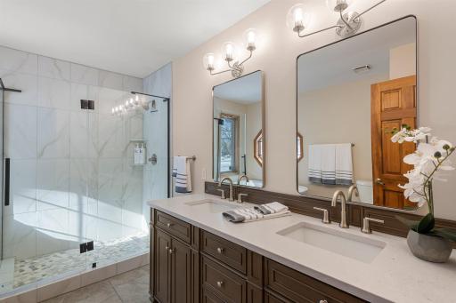 Recently updated, the en-suite bathroom boasts a luxurious standalone soaking tub, a beautifully tiled shower, and a dual vanity.