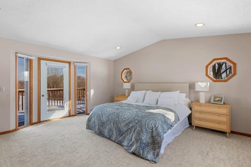 The primary suite is a true retreat, featuring a large walk-in closet and private doors leading out to the expansive deck.