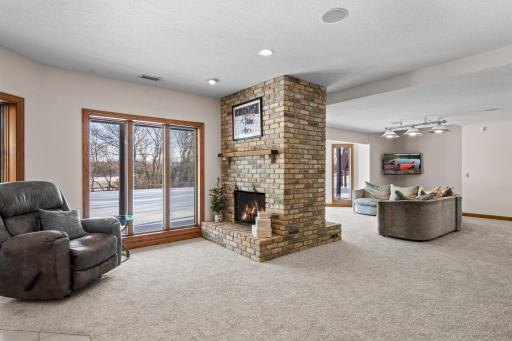 The adjacent sitting area, featuring a two-sided fireplace, is perfect for cozy gatherings.