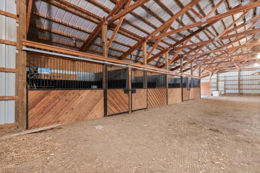 Featuring 14 stalls, 4 foal stalls, a shop space for storage, and large garage doors for easy access to larger vehicles.