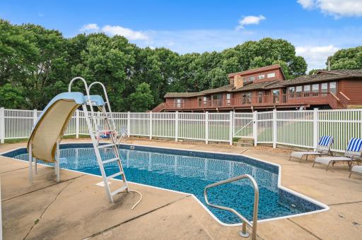 A below-ground pool with a slide offers fun for all ages.