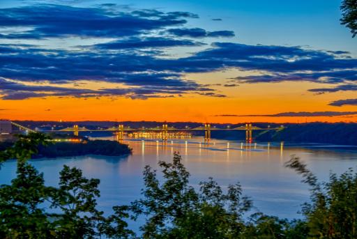 Tucked at a peaceful bend in the river, this property enjoys rare north and south views, including unforgettable sunsets and the twinkling lights of Stillwater in the distance.