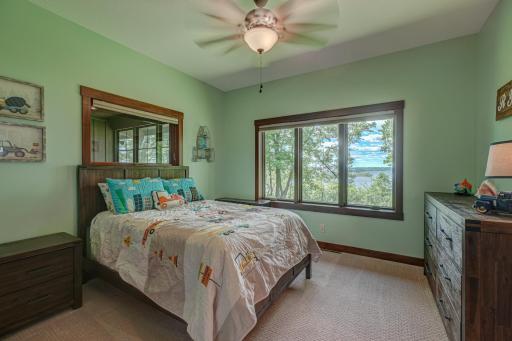 Two additional main-level bedrooms offer spacious layouts, stunning river views, and share a well-appointed Jack & Jill bath. Bedroom #2