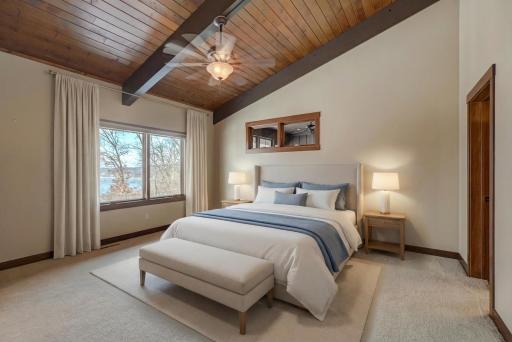 Wake up to captivating river sunrises in the private primary suite, complete with a walk-in closet and a spa-like ensuite featuring heated floors, a jetted tub, and a natural stone tile shower.