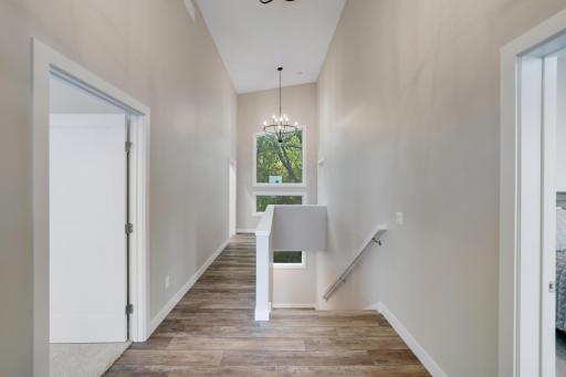 Hallway to all Bedrooms/Laundry and beautiful window overlooking woods and Gilbert Creek