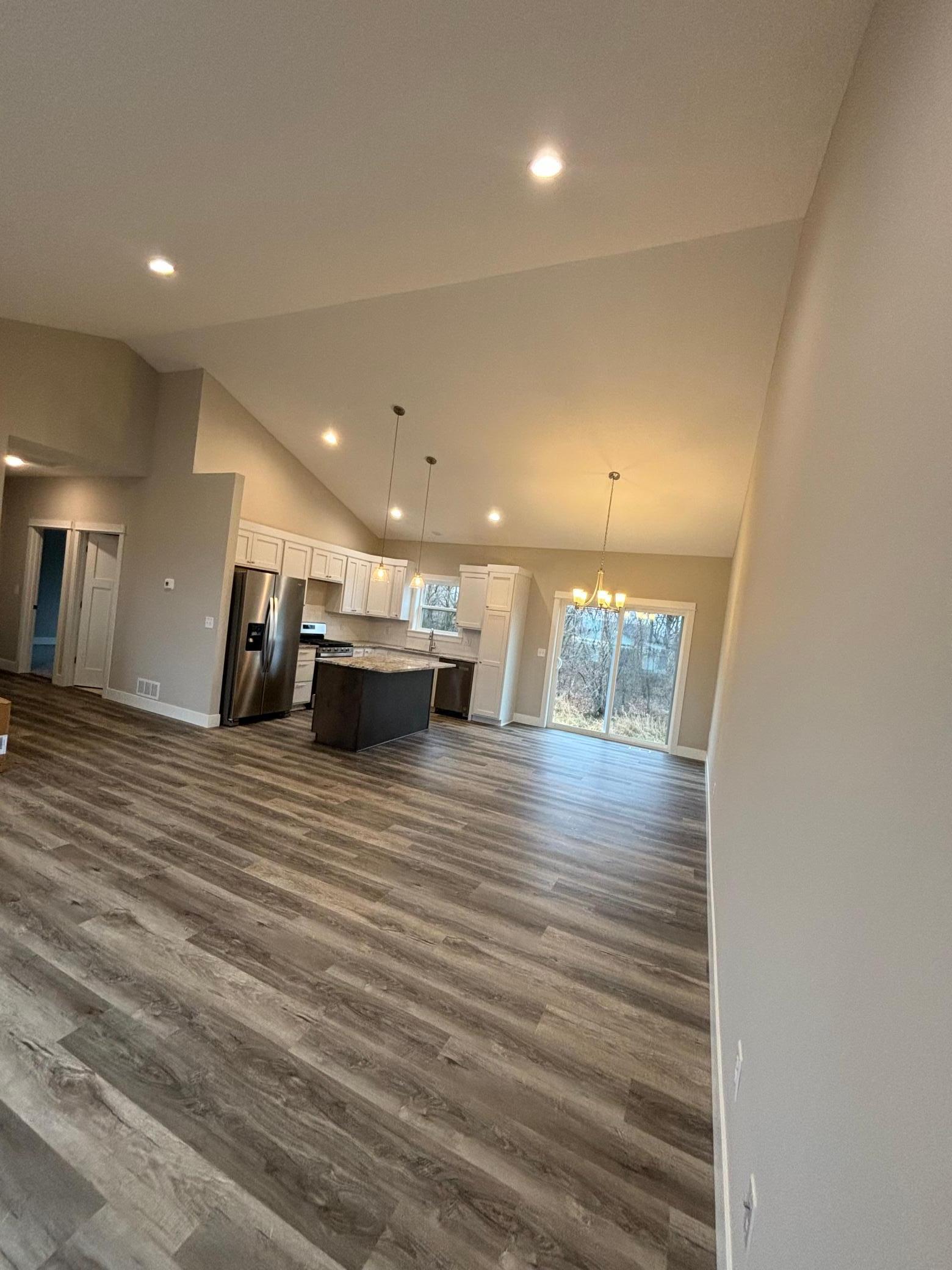 Open Concept Kitchen includes large center island, granite counter tops, tiled backsplash and soft close cabinetry