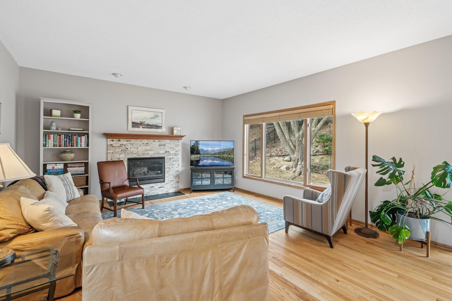 This family room is larger than it looks and its focal point is this beautiful gas fireplace and huge picture window