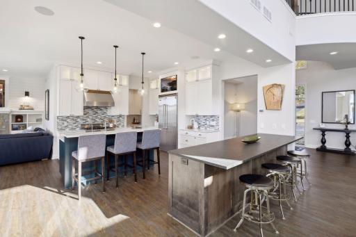 Double islands - plenty of seating and workspace. Enjoy the beverage refrigerator and the icemaker in the island with the leathered granite countertop.