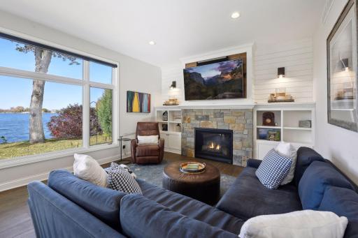 Cozy family room with gas fireplace, shiplap wall, and built in bookshelves
