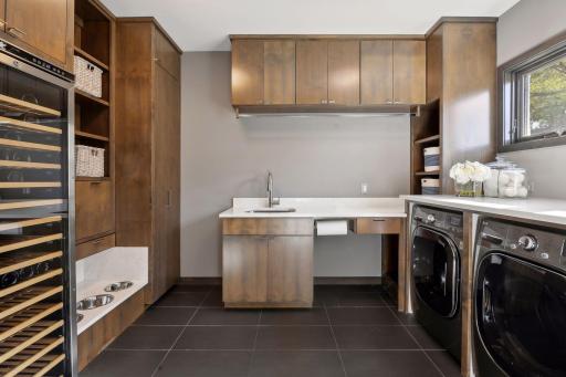 Originally the garage, this area was finished off beautifully and is currently enjoyed as a laundry room with a wine cooler and built in dog bowl system.
