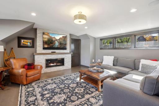 Upper-level amusement room with extra wide fireplace.
