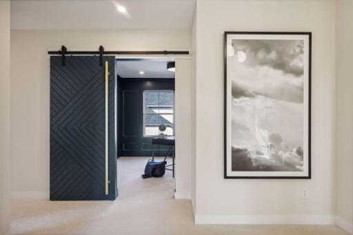 Explore the study room, highlighted by a charming barn door.