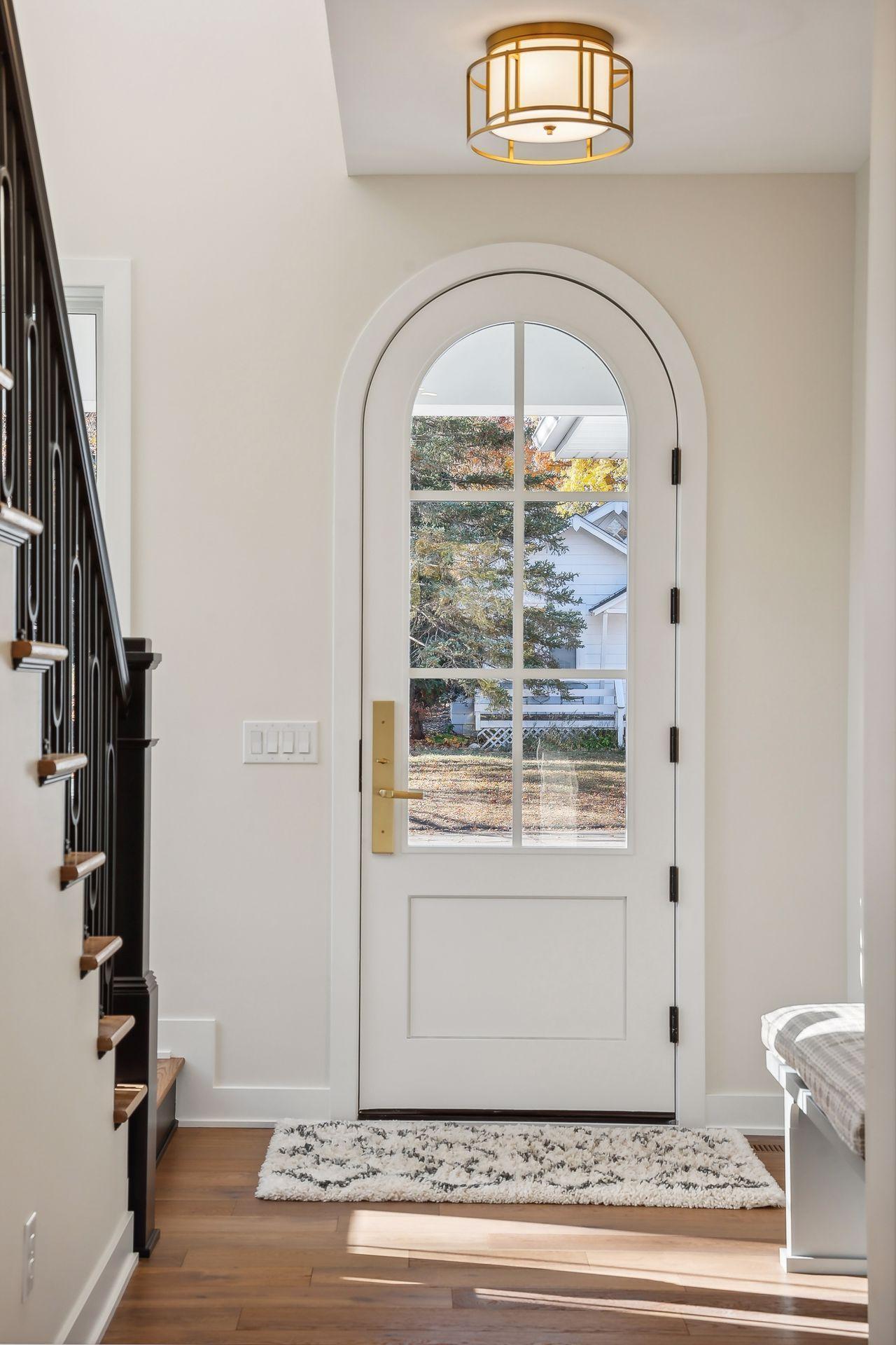 Welcome guests through the impressive 8-foot arched door, setting a grand tone for the home's entrance.