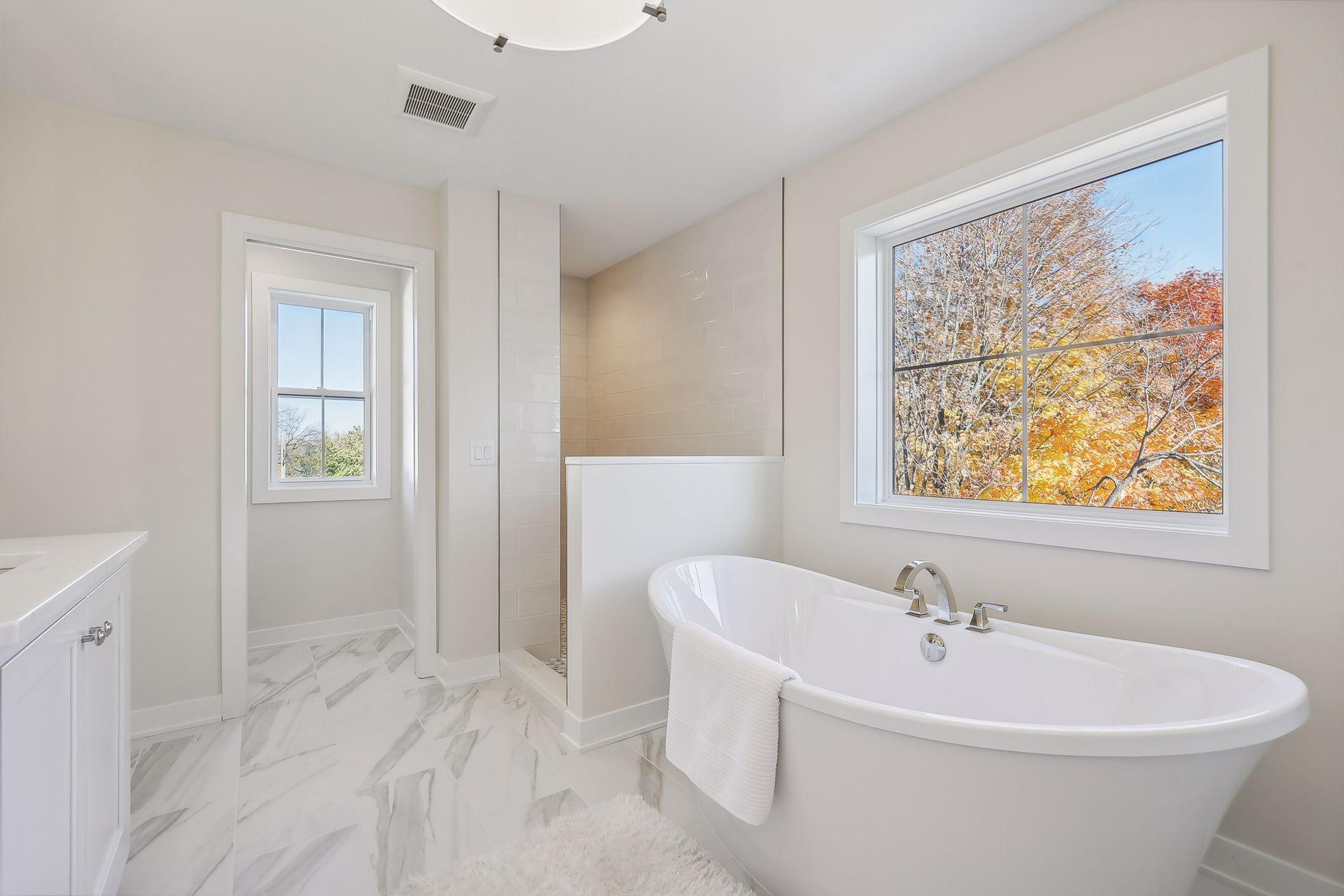 Relax in the primary bathroom's luxurious soaker tub, offering a perfect retreat for unwinding.