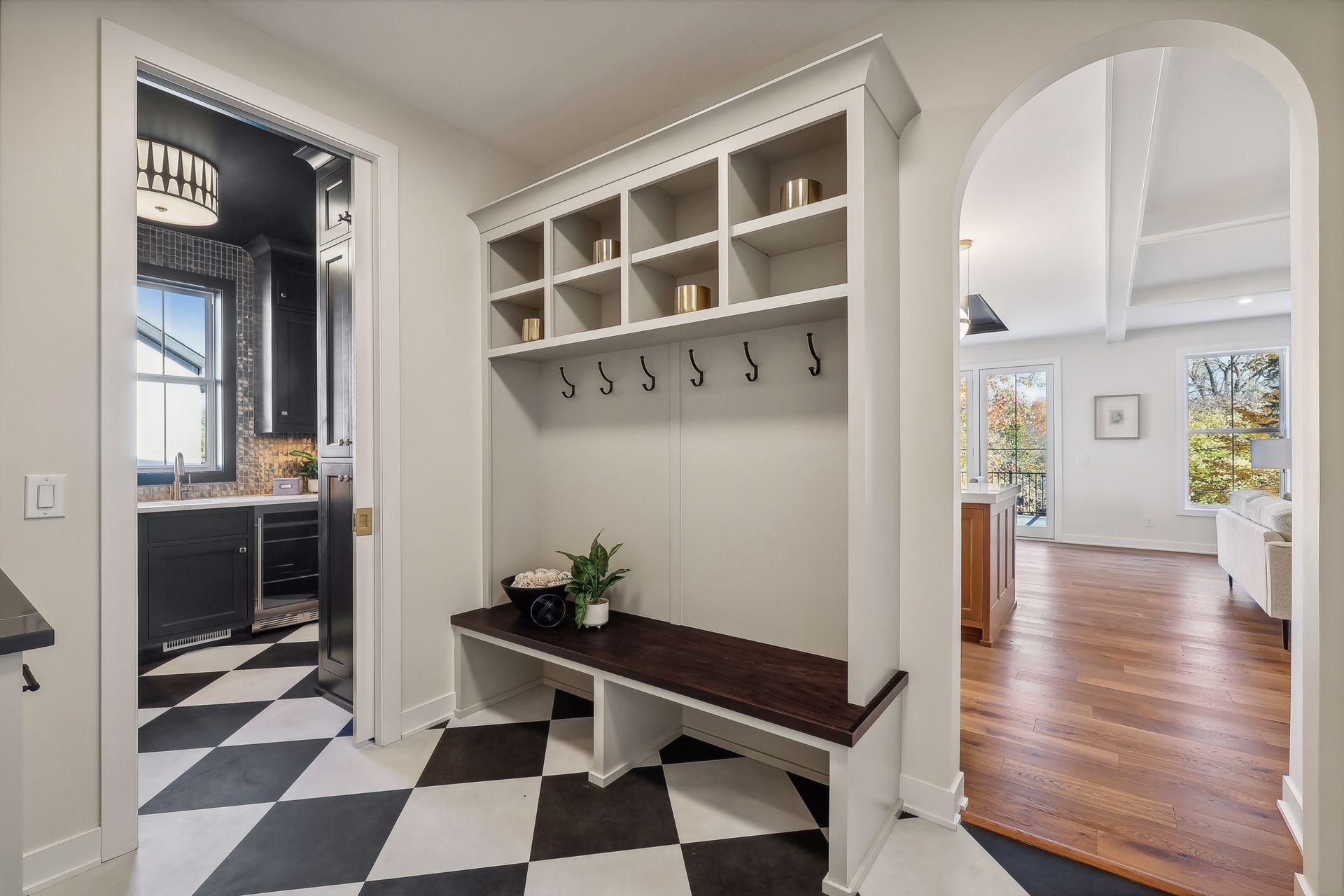 Step into the stylish mudroom, featuring chic diamond-patterned flooring for a touch of elegance and practicality.