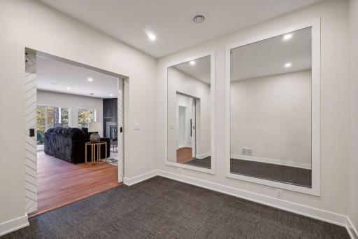 Achieve your fitness goals in the thoughtfully designed exercise room, featuring framed mirror panels for a spacious and motivating atmosphere.