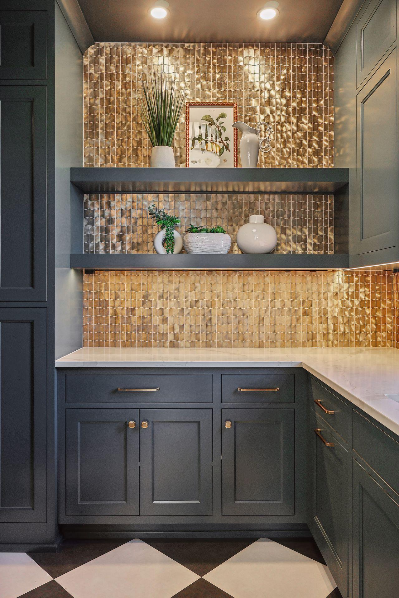 Step into a pantry paradise, featuring a striking gold backsplash and abundant cabinet space to accommodate all your culinary needs