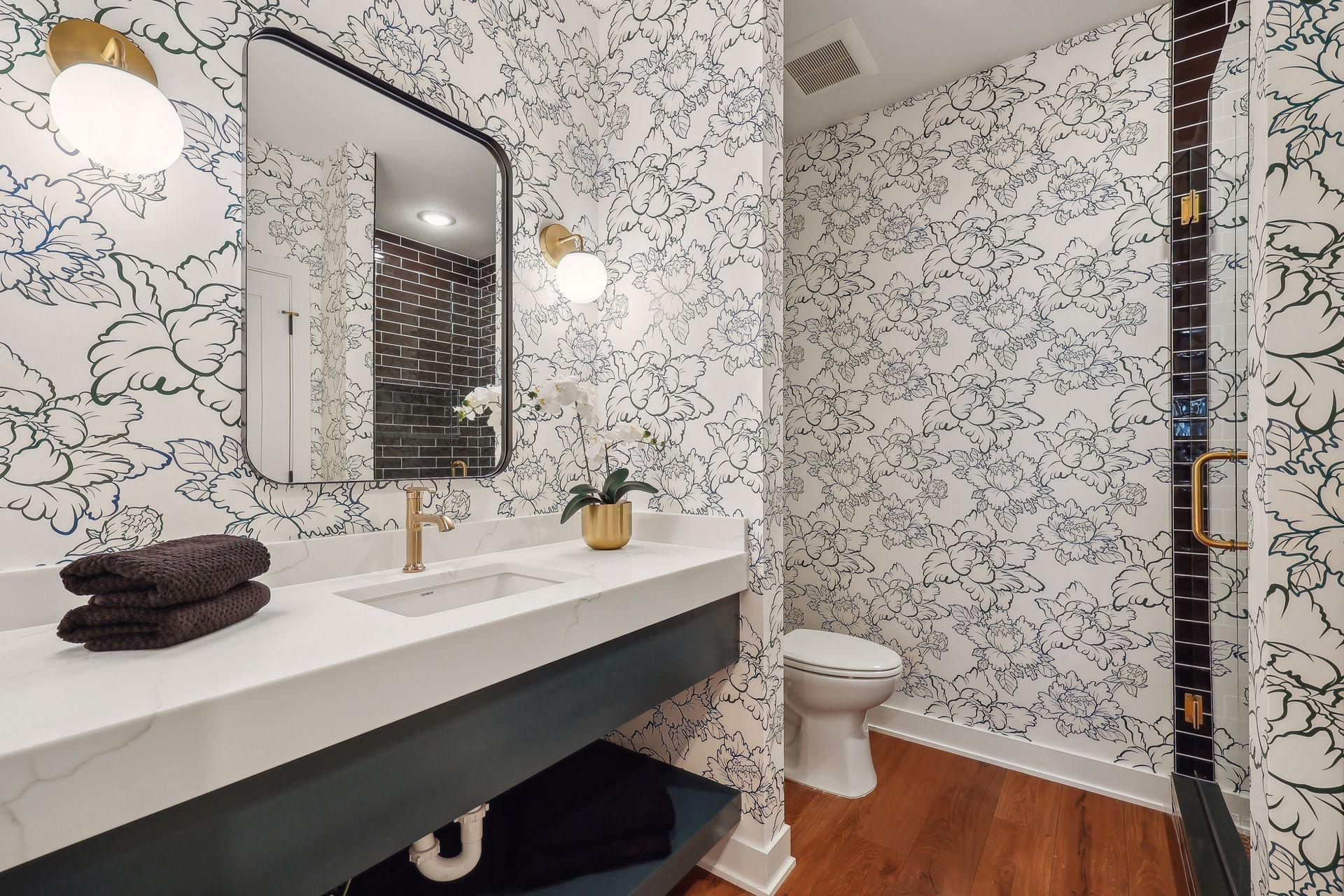 Discover the lower level 3/4 bathroom, featuring a sleek floating vanity with a convenient lower shelf for added storage.