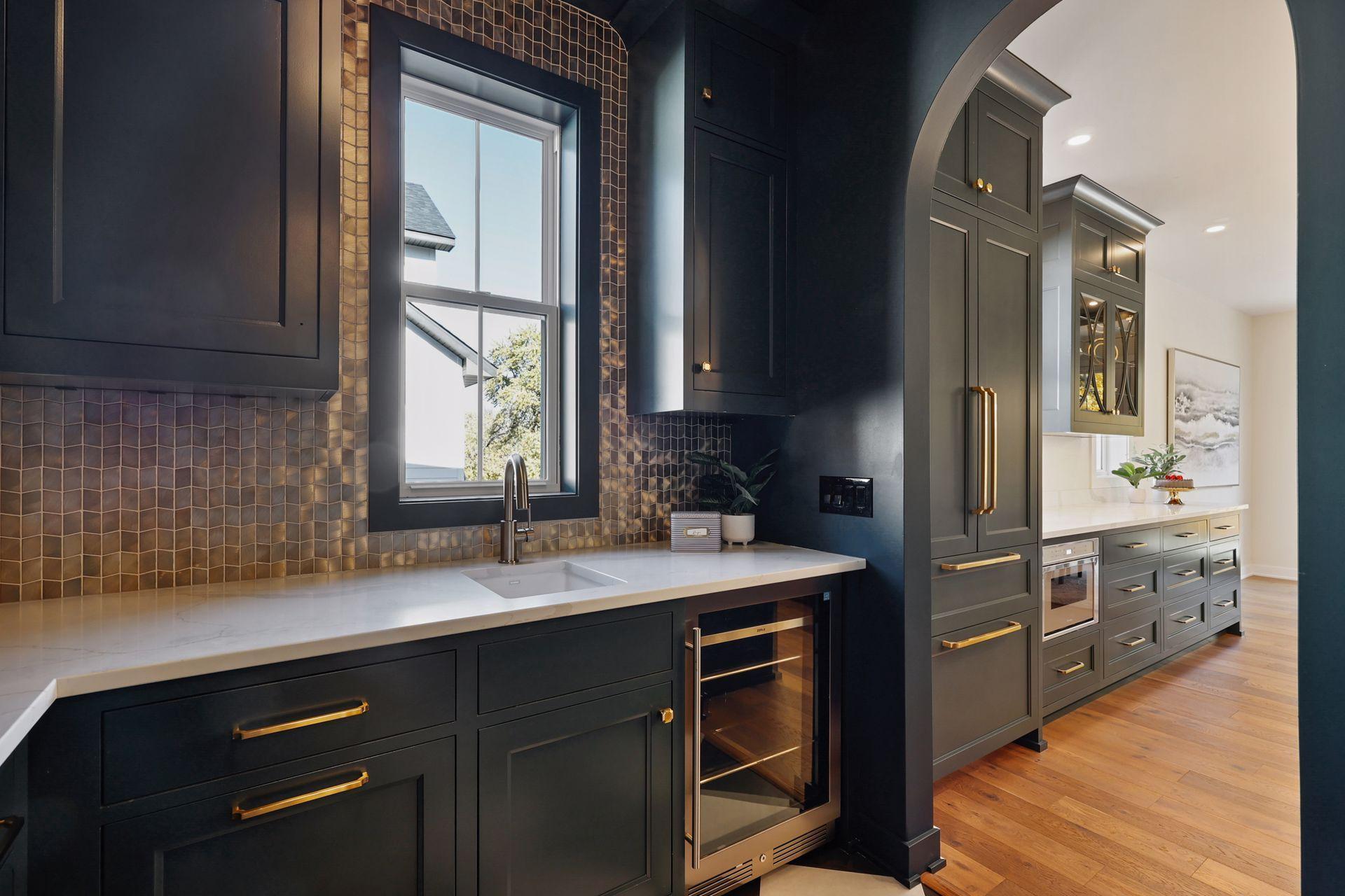 Back pantry includes sink, beverage fridge, and plentiful storage.
