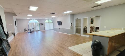 Community Room with kitchen, tables, chairs - great space to reserve for parties.jpg