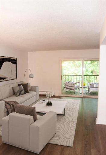 Photo for 12850 Nicollet Avenue, 301, Burnsville, MN 55337 - listing #6619398 (Virtually staged) - Living room opens to covered deck with beautiful tree- filled courtyard views. This is a great location in the community and an awesome outdoor space in this upper level condo.