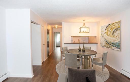 (Virtually staged) - Dining room is open to living room and pass-through window to kitchen with counter for bar stools