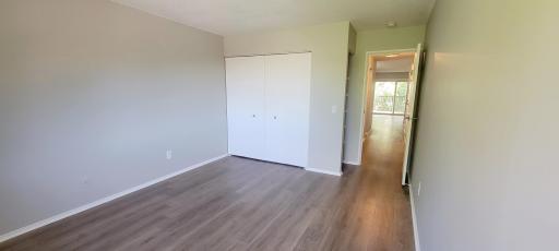 View down hall from bedroom. Light flows all the way through this unit with windows at both sides of the condo.