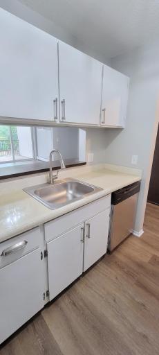 Bar height counter connects kitchen to living room. Pass through window keeps window open to dining and living rooms.