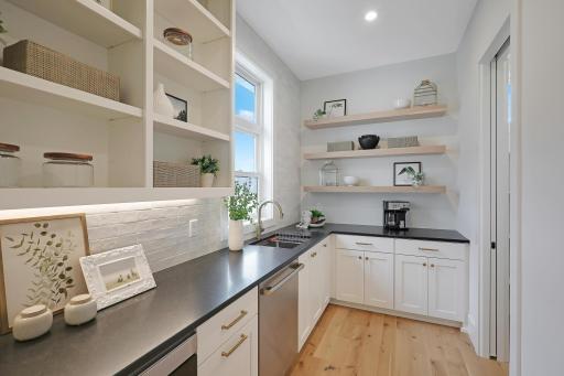 The butler's pantry also has an additional storage room keeping everything just steps away.