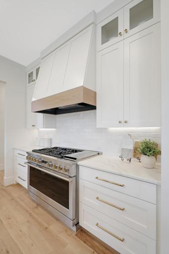 An extra large stove and over flanked by convenient and stylish storage.