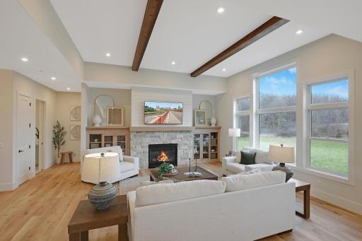 The glow of the gas fireplace provides light and warmth. The stone facade and built-ins add subtle elegance.
