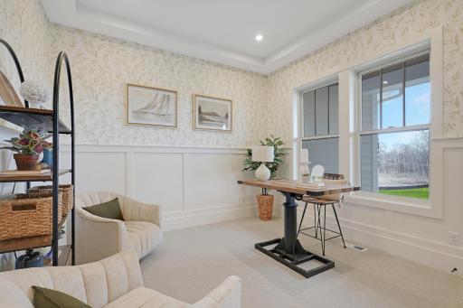 The office is all business with wainscoting and contemporary wallpaper adding stylishness.
