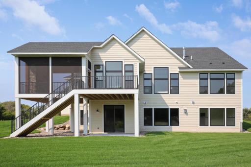 The expansive back of this magnificent home offers seamless access to the lush 20-acre property from both the main and lower levels.