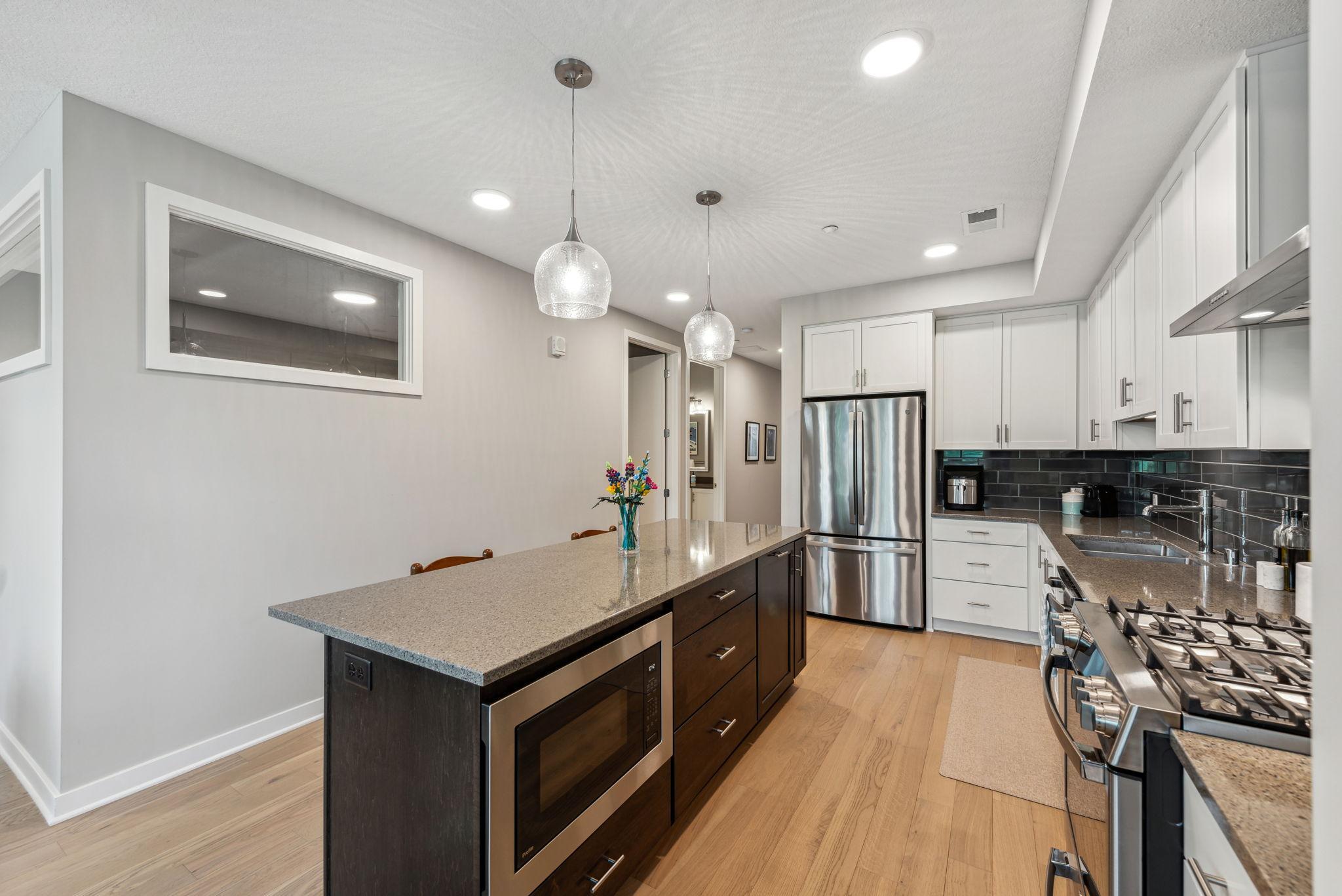 Beautiful kitchen with white cabinetry, Stainless Steel appliances and modern finishes.