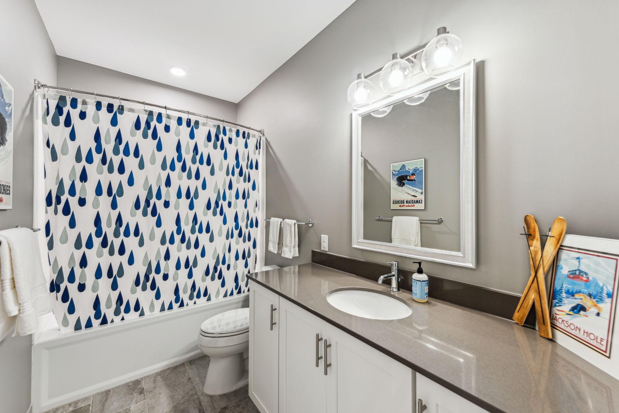 Second bath with shower and built-in vanity with Quartz countertops..