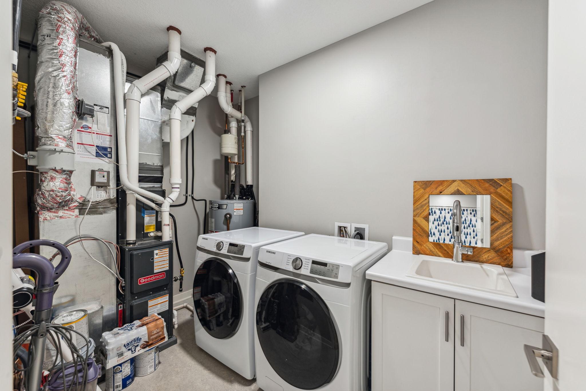 Laundry and utility room with extra space for storage.