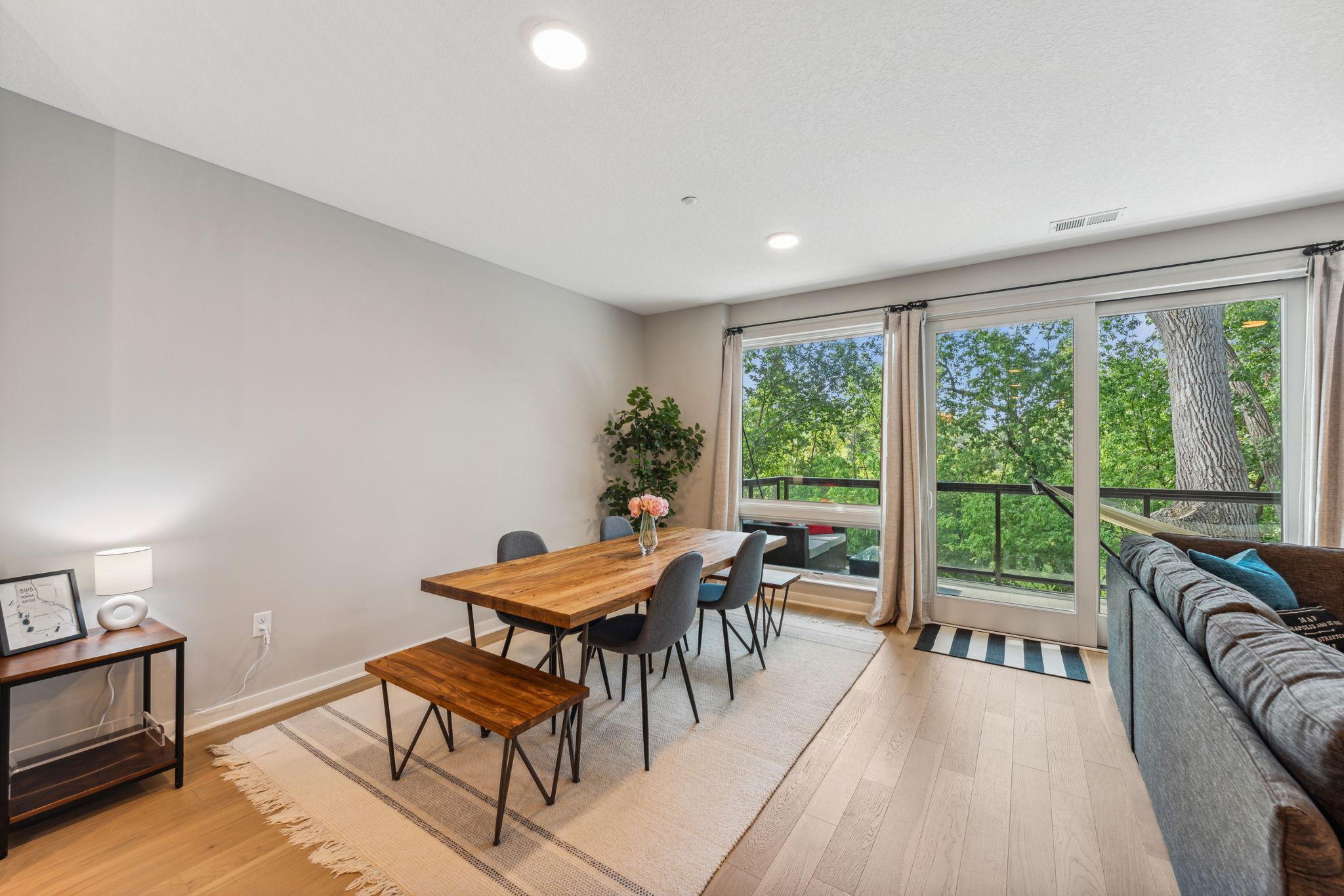Lovely dining area with floor to ceiling windows taking in the views of the private, wooded back area.
