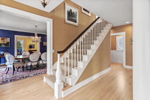 The gracious dining room is to the left, and the half bath is to the right.