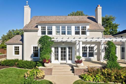 The entry has an expansive terrace overlooking the front lawn