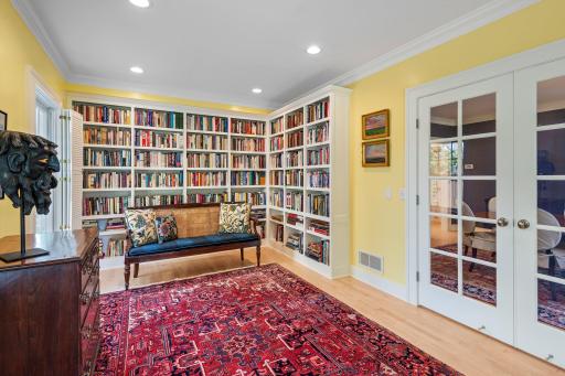 The den's french doors lead to the dining room.