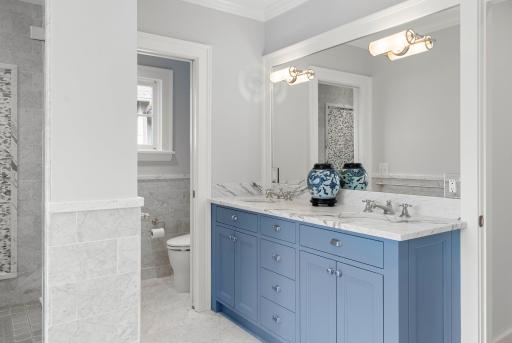 Primary bath with double vanity, tub, and walk-in shower.