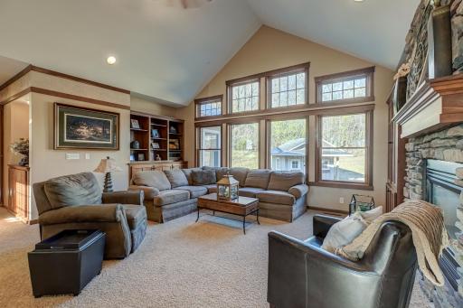 Multiple living areas connected by a cozy, double-sided fireplace.